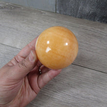 Load image into Gallery viewer, Large Orange Calcite Sphere
